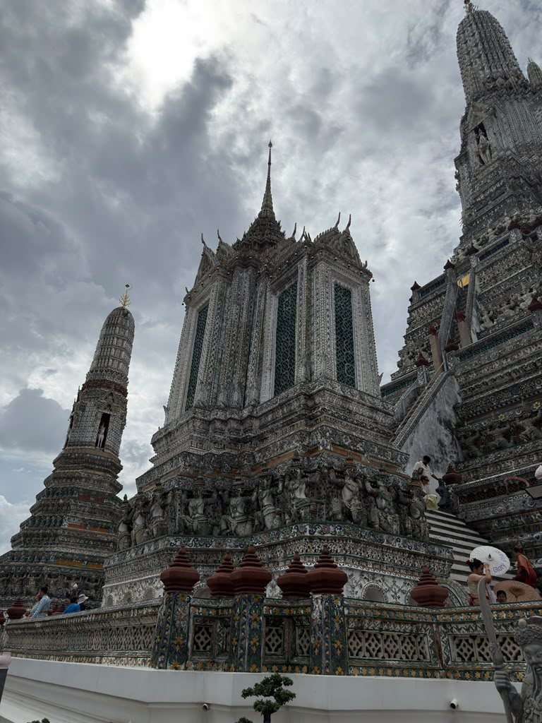 Wat Arun temple beneath a dramatic Bangkok sky