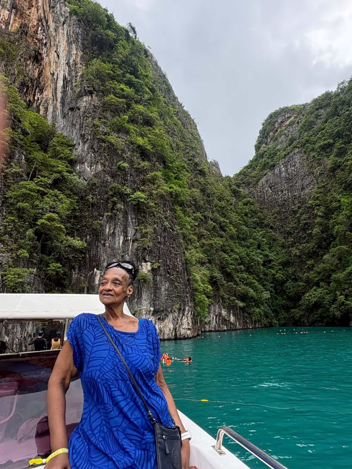 Traveler taking in the limestone cliffs and blue water