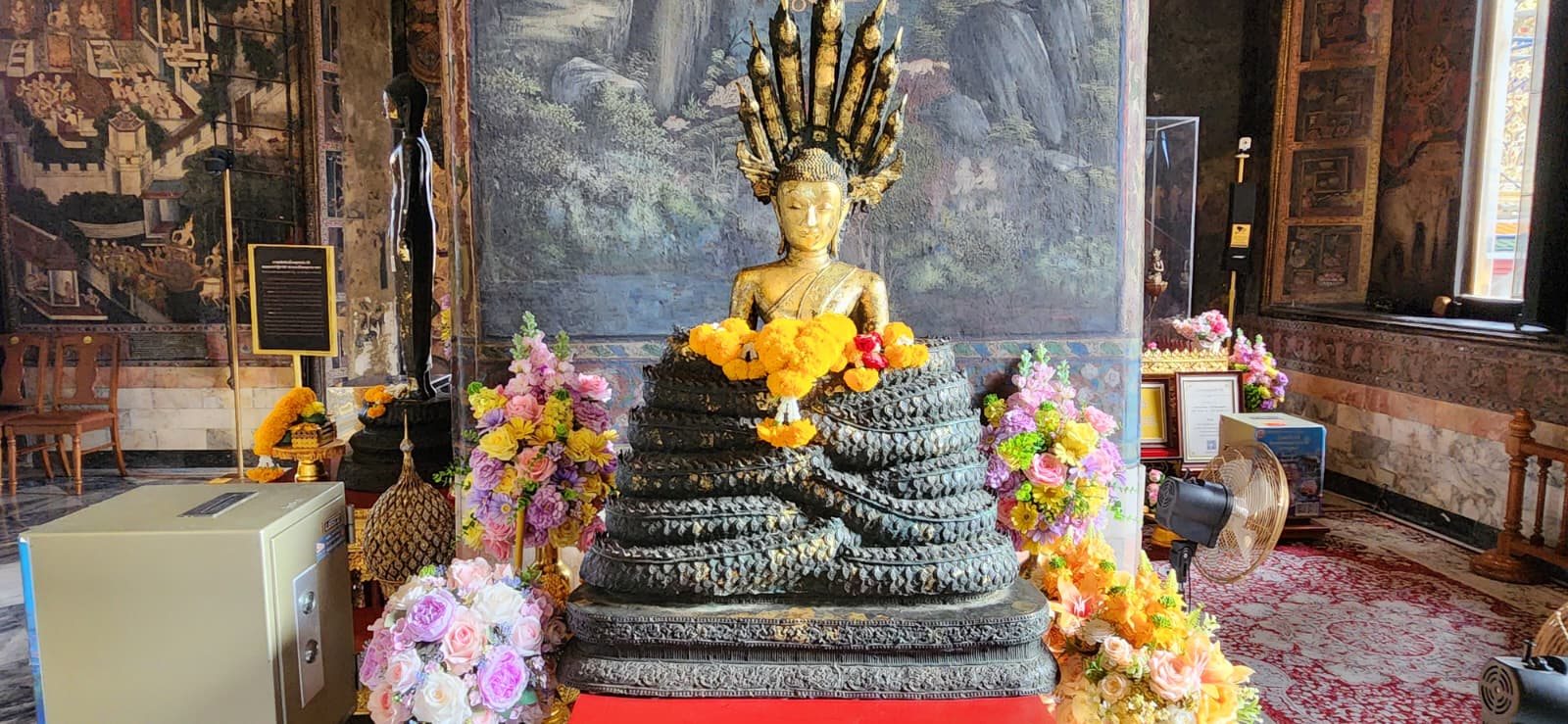 Buddha shrine decorated with flowers in Bangkok